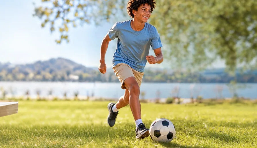Child playing soccer outdoors